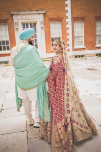 Sikh couple walks through a palace Sikh couple walking